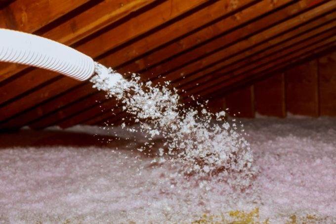 Improving home insulation by blowing in attic insulation